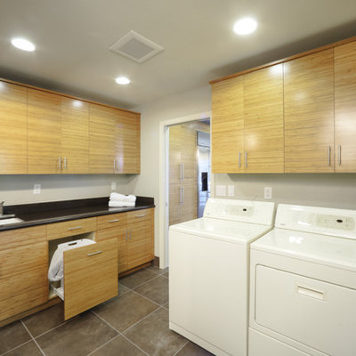 Example of a trendy laundry room design in Sacramento with gray walls and medium tone wood cabinets