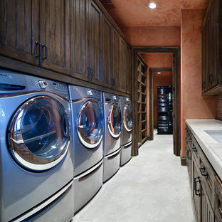 Huge tuscan galley beige floor dedicated laundry room photo in Houston with an undermount sink, recessed-panel cabinets, dark wood cabinets, a side-by-side washer/dryer and beige countertops