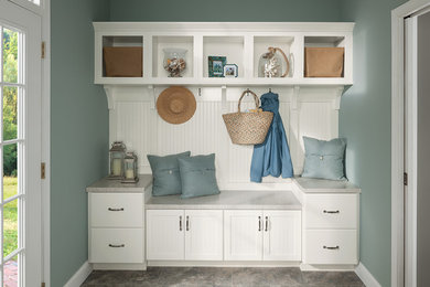 Example of a transitional laundry room design in DC Metro with white cabinets and solid surface countertops