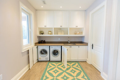 Example of a transitional laundry room design in Toronto