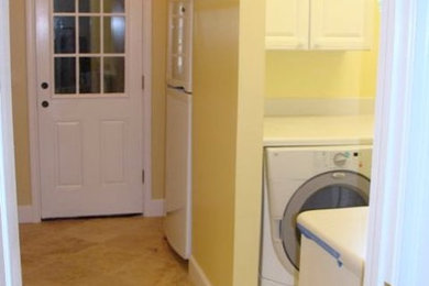 Inspiration for a medium sized classic utility room in Jacksonville with raised-panel cabinets, white cabinets, yellow walls, ceramic flooring and a side by side washer and dryer.