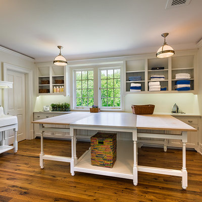 Inspiration for a large timeless l-shaped dark wood floor and brown floor dedicated laundry room remodel in Philadelphia with beige cabinets, an utility sink, shaker cabinets, wood countertops, beige walls, a side-by-side washer/dryer and beige countertops