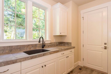 Example of a transitional laundry room design in Portland