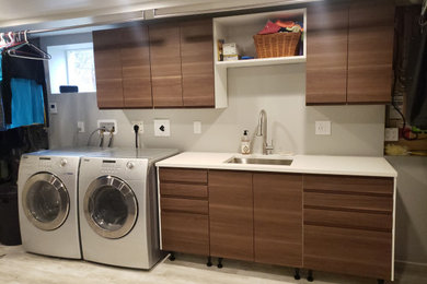 Inspiration for a large modern galley vinyl floor utility room remodel in Edmonton with an undermount sink, flat-panel cabinets, medium tone wood cabinets, quartz countertops, gray walls, a side-by-side washer/dryer and white countertops
