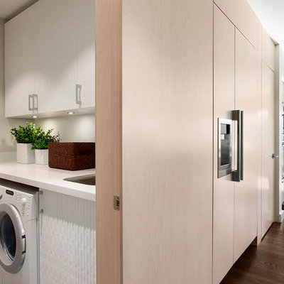 Example of a trendy laundry room design in Vancouver with beige walls and white countertops