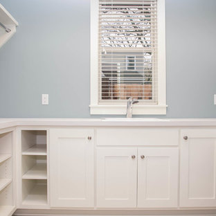 Laundry closet - transitional u-shaped ceramic tile laundry closet idea in Minneapolis with an undermount sink, shaker cabinets, white cabinets, laminate countertops and blue walls