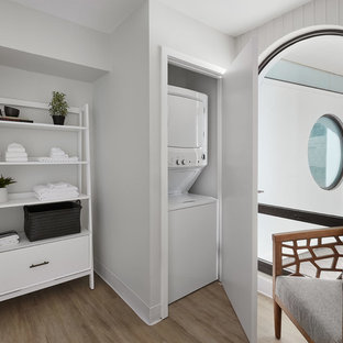 Laundry closet - contemporary light wood floor and beige floor laundry closet idea in Chicago with gray walls and a stacked washer/dryer