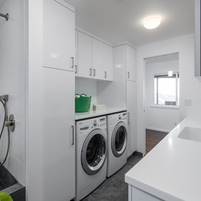 Mid-sized trendy galley utility room photo in Portland with flat-panel cabinets, white cabinets, white walls and a side-by-side washer/dryer