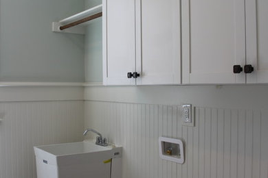 Mountain style ceramic tile and gray floor laundry room photo in Raleigh with shaker cabinets, white cabinets and a side-by-side washer/dryer
