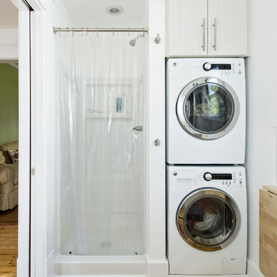 Elegant utility room photo in Louisville with a stacked washer/dryer