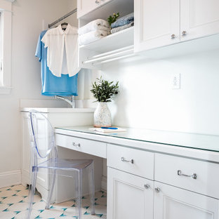 Immagine di una piccola sala lavanderia stile marinaro con lavello sottopiano, ante in stile shaker, ante bianche, top in vetro, pavimento con piastrelle in ceramica, lavatrice e asciugatrice affiancate, pavimento blu, top bianco e pareti bianche