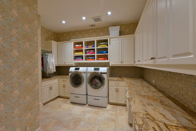 Utility room - huge traditional u-shaped porcelain tile utility room idea in Austin with a single-bowl sink, raised-panel cabinets, white cabinets, laminate countertops, multicolored walls and a side-by-side washer/dryer