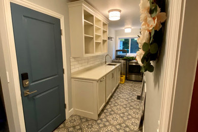 Dedicated laundry room - mid-sized farmhouse l-shaped porcelain tile and blue floor dedicated laundry room idea in Portland with an undermount sink, recessed-panel cabinets, white cabinets, quartz countertops, blue walls, a side-by-side washer/dryer and beige countertops