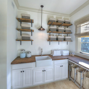 Esempio di una lavanderia costiera con lavello stile country, pareti bianche, top in legno e top marrone
