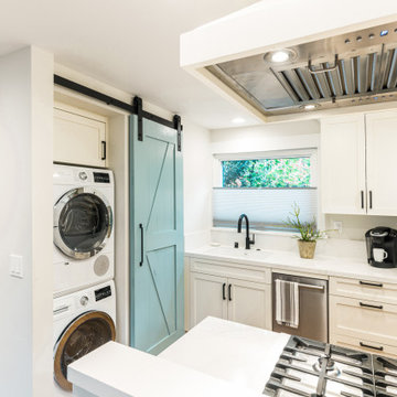 Stacked Washer and Dryer in Hidden Laundry Closet with Sliding Barn Door