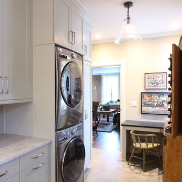 Stacked Washer Dryer with Built in Desk in Hardworking Laundry Room
