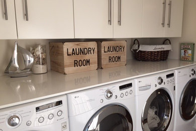 Laundry room - contemporary laundry room idea in Montreal