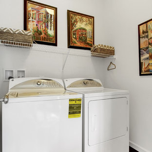 Dedicated laundry room - small transitional single-wall dark wood floor dedicated laundry room idea in Philadelphia with white walls and a side-by-side washer/dryer