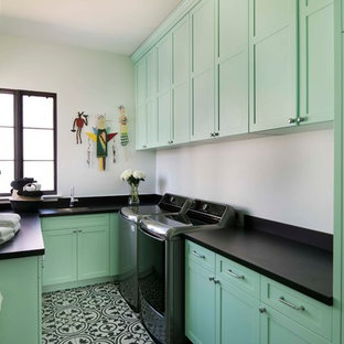 Immagine di una sala lavanderia mediterranea con lavello sottopiano, ante in stile shaker, ante verdi, pareti bianche, lavatrice e asciugatrice affiancate e pavimento multicolore