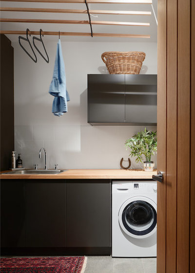Scandinavian Laundry Room by Craftsmen Quality Builders