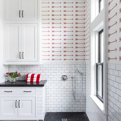 Inspiration for a large country u-shaped limestone floor and black floor utility room remodel in New York with an undermount sink, recessed-panel cabinets, white cabinets, concrete countertops, red walls, a side-by-side washer/dryer and gray countertops