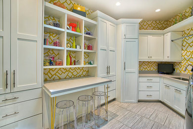 Utility room - large contemporary u-shaped utility room idea in Phoenix with a drop-in sink, recessed-panel cabinets, white cabinets, multicolored walls, a side-by-side washer/dryer and gray countertops