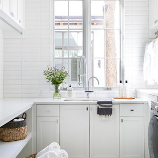 Example of a tuscan u-shaped multicolored floor dedicated laundry room design in Austin with an undermount sink, shaker cabinets, white cabinets, white walls and white countertops