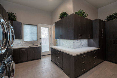 Mid-sized minimalist l-shaped utility room photo in Phoenix with an undermount sink, flat-panel cabinets, dark wood cabinets, quartz countertops and beige walls
