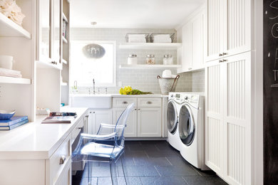 Inspiration for a small timeless u-shaped slate floor and gray floor utility room remodel in San Francisco with a farmhouse sink, shaker cabinets, white cabinets, quartz countertops, a side-by-side washer/dryer, gray walls and white countertops