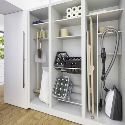 Large trendy single-wall light wood floor and brown floor laundry room photo in Barcelona with flat-panel cabinets and white cabinets