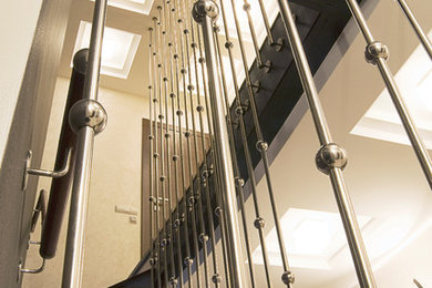 This is an example of a medium sized wood l-shaped staircase in Moscow with metal risers.