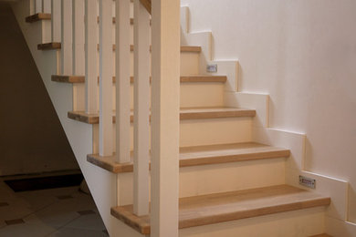 Design ideas for a medium sized scandi wood u-shaped staircase in Moscow with wood risers.