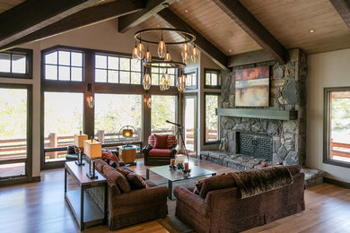 Inspiration for a rustic formal living room remodel in Salt Lake City with brown walls, a standard fireplace, a stone fireplace and no tv