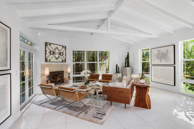 Mid-sized 1950s formal and open concept travertine floor and white floor living room photo in Miami with white walls, a standard fireplace and a plaster fireplace