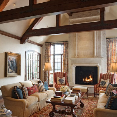 Inspiration for a mediterranean living room remodel in Wichita with beige walls and a standard fireplace