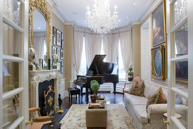 Example of a classic enclosed dark wood floor living room design in New York with a music area, beige walls, a standard fireplace and no tv