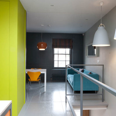Urban loft-style living room photo in Other with gray walls