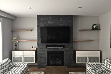 Living room - mid-sized contemporary open concept light wood floor living room idea in Ottawa with gray walls, a standard fireplace, a stone fireplace and a wall-mounted tv