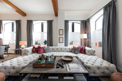 Imagen de salón abierto actual con paredes beige y suelo de madera en tonos medios
