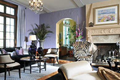 На фото: большая парадная, изолированная гостиная комната в стиле фьюжн с фиолетовыми стенами, паркетным полом среднего тона, стандартным камином, фасадом камина из камня и бежевым полом без телевизора