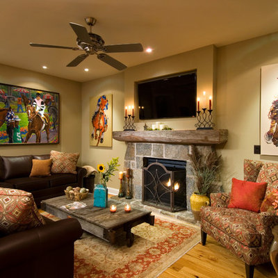 Living room - cottage medium tone wood floor living room idea in New York with beige walls, a standard fireplace, a stone fireplace and a wall-mounted tv