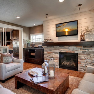 Living room - rustic open concept living room idea in Minneapolis with a standard fireplace