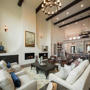 Example of a tuscan formal and open concept dark wood floor and brown floor living room design in Austin with white walls, a standard fireplace, a metal fireplace and no tv