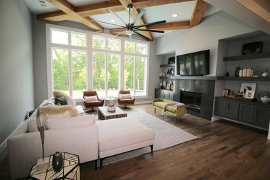 Living room - mid-sized transitional open concept light wood floor and gray floor living room idea in Other with gray walls, a standard fireplace and a wall-mounted tv