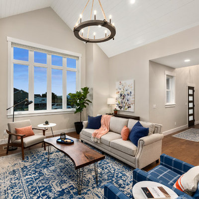 Example of a large cottage formal and open concept medium tone wood floor and brown floor living room design in Salt Lake City with beige walls, a standard fireplace, a brick fireplace and a wall-mounted tv