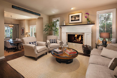 Traditional living room in Santa Barbara with dark hardwood flooring and a stone fireplace surround.