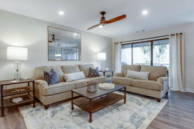Imagen de salón marinero de tamaño medio con paredes beige, suelo laminado, televisor independiente y suelo marrón