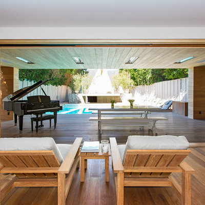 Living room - modern medium tone wood floor living room idea in Los Angeles with a music area