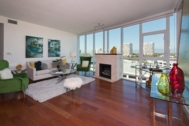 Example of a small minimalist open concept dark wood floor and brown floor living room design in Orange County with white walls, a standard fireplace and a tile fireplace