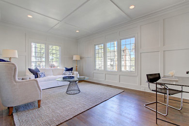 This is an example of a medium sized coastal living room in New York with white walls and medium hardwood flooring.